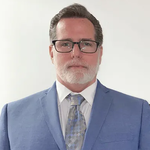 David Cabrera - Paralegal at Hayes Hunter P.C. in blue suit wearing glasses