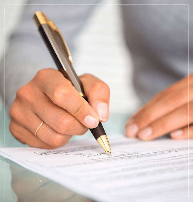 Hands signing wills trust probate document