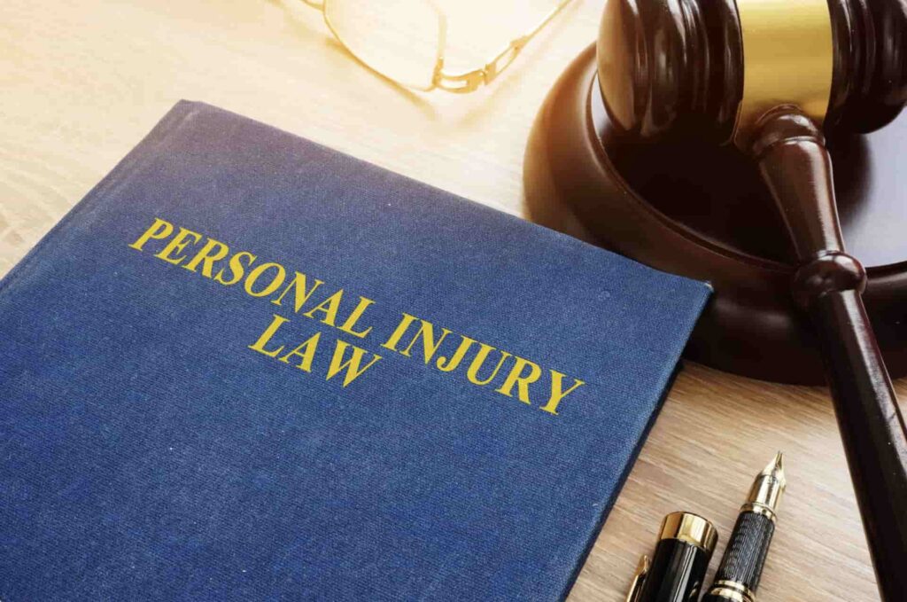 Personal Injury Law book in Houston Texas with gavel, pens and glasses on an attorney's desk