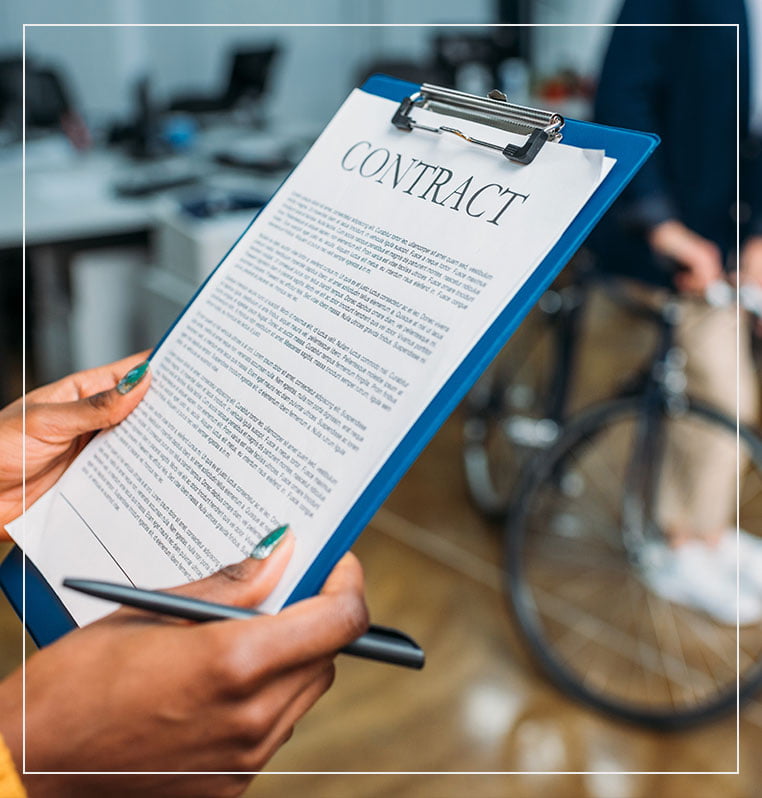 Woman signing business law contract on blue clipboard